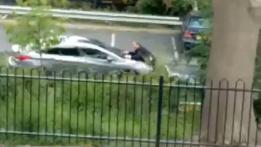 Man wanted for assault after driving away with police officer on his bonnet